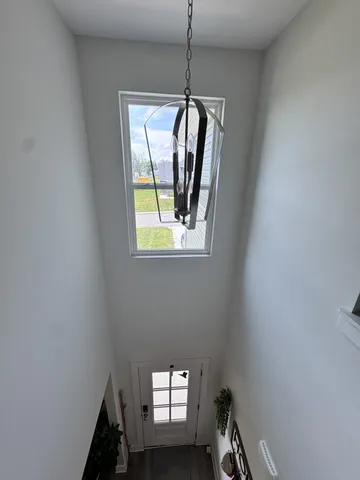 a picture of a room with window and stairs