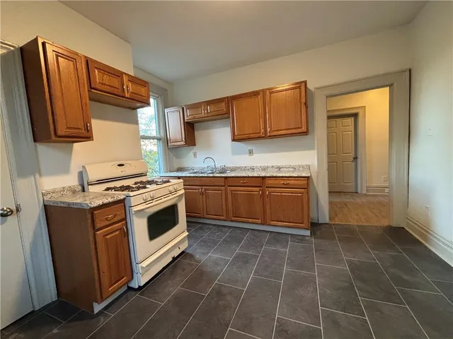 a kitchen with a stove sink and cabinets
