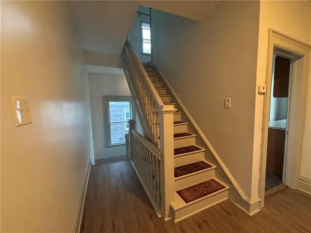 a view of entryway and hall with wooden floor