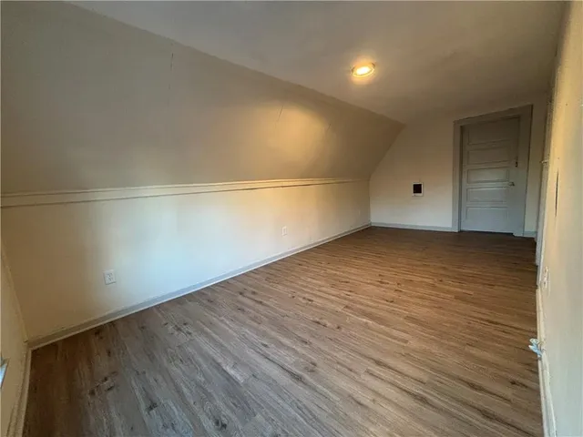 a view of a room with wooden floor