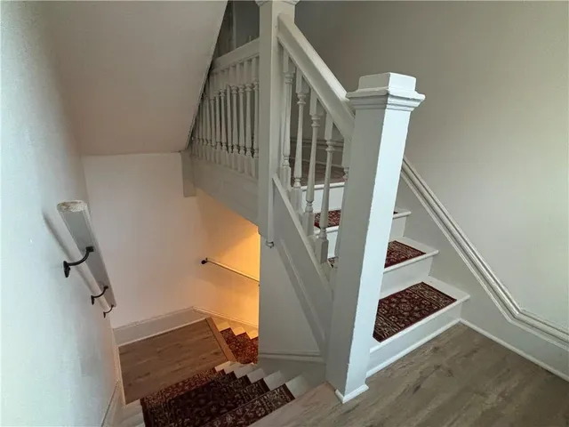 a view of entryway and hall with wooden floor
