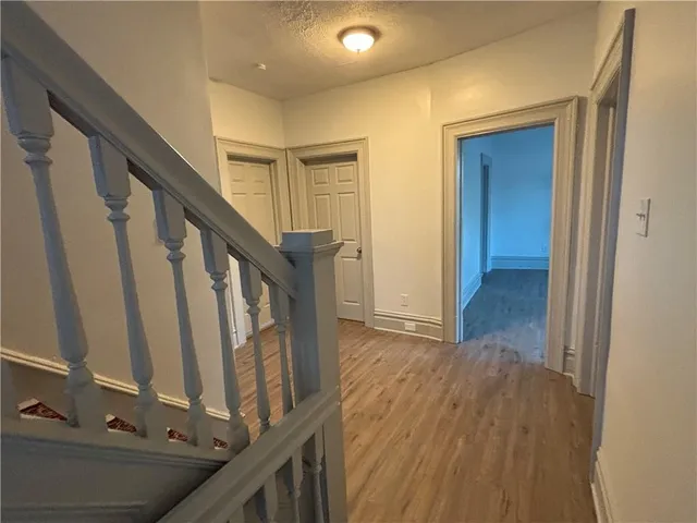 a view of an entryway with wooden floor