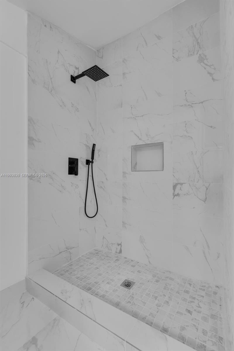 6295 Southwest 29th Street, Unit 1 Miami, FL 33155 - Photo 13 of 15 a bathroom with a glass shower