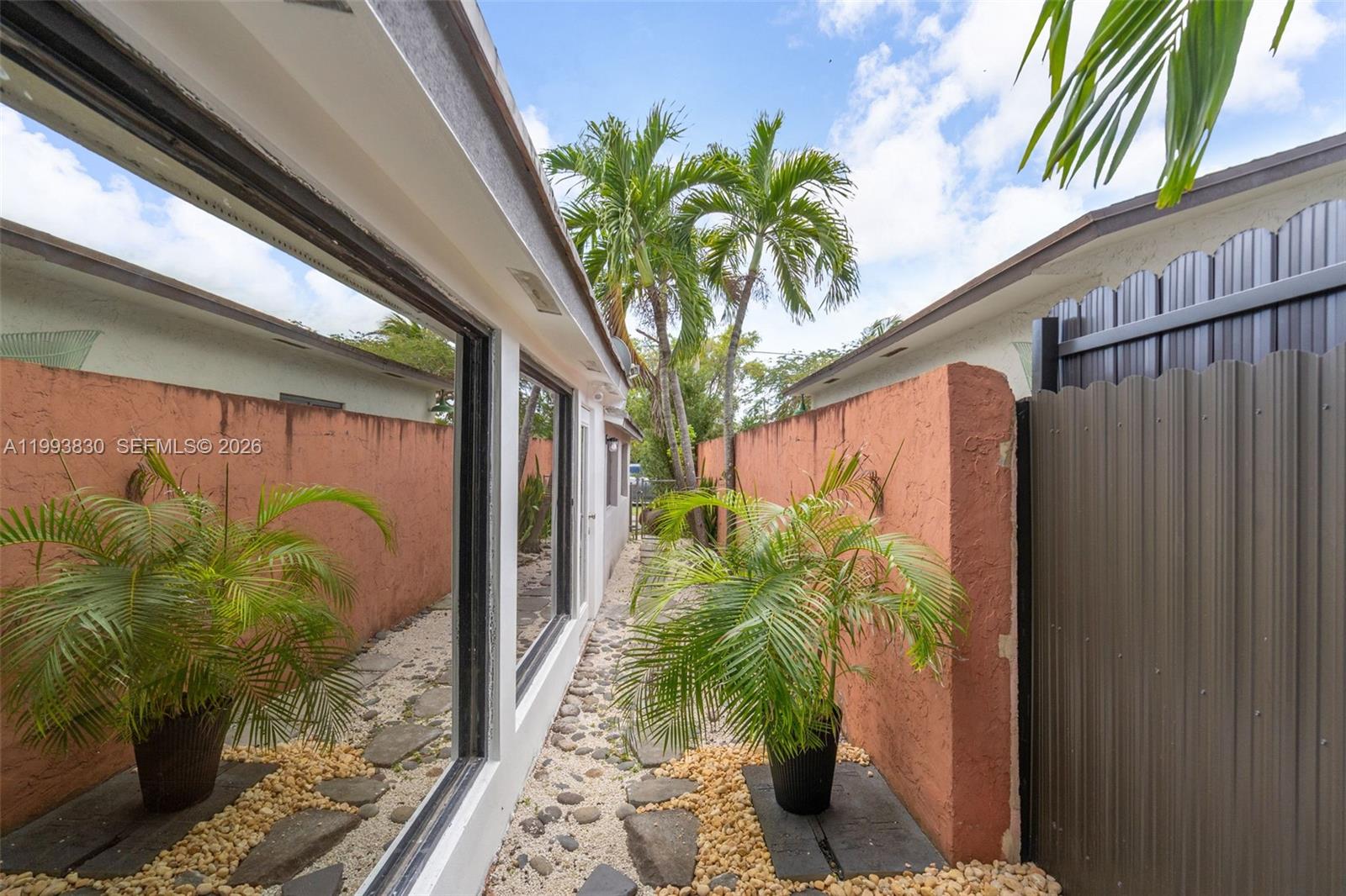 6295 Southwest 29th Street, Unit 1 Miami, FL 33155 - Photo 14 of 15 a plant is in front of a glass door