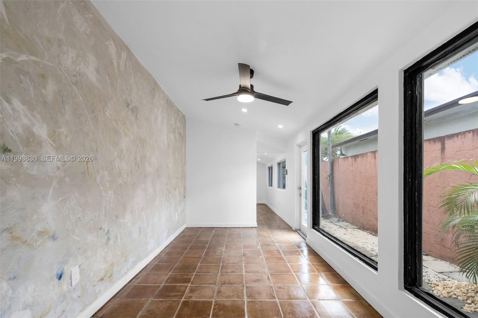 6295 Southwest 29th Street, Unit 1 Miami, FL 33155 - Photo 7 of 15 a view of a hallway with a glass door and a window