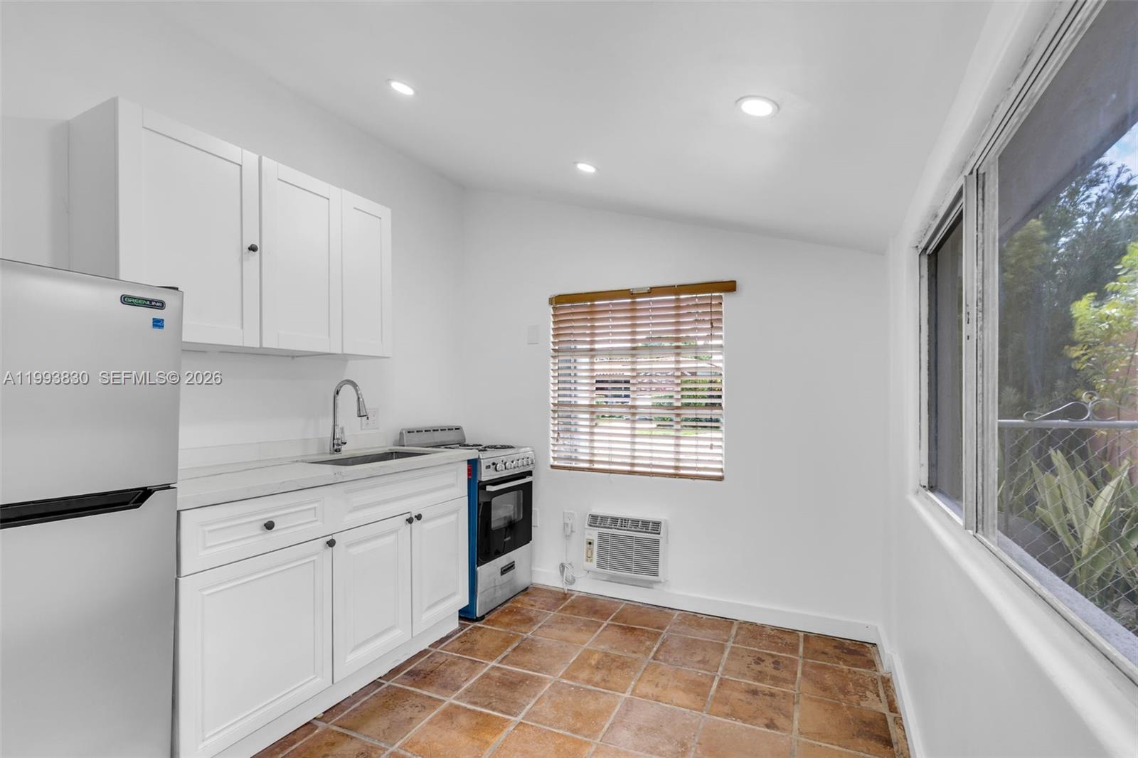 6295 Southwest 29th Street, Unit 1 Miami, FL 33155 - Photo 8 of 15 a view of a kitchen with a sink dishwasher and wooden cabinets