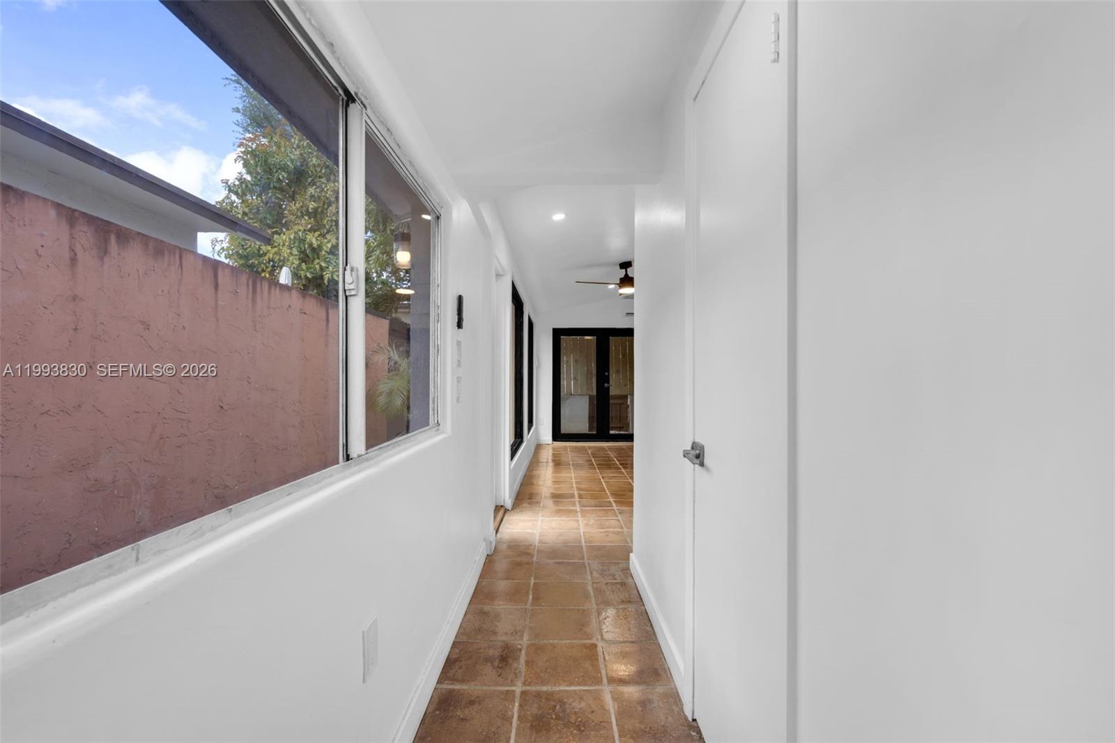 6295 Southwest 29th Street, Unit 1 Miami, FL 33155 - Photo 10 of 15 a view of a hallway with wooden floor and a large window