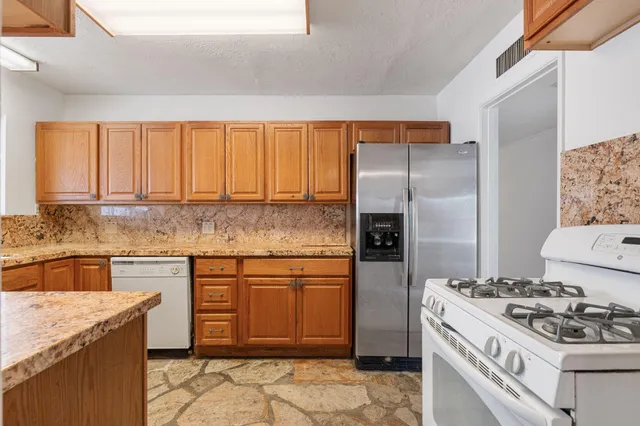 a kitchen with a stove a sink and a refrigerator