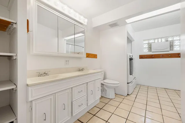 a view of a bathroom with 2 sink toilet and a shower