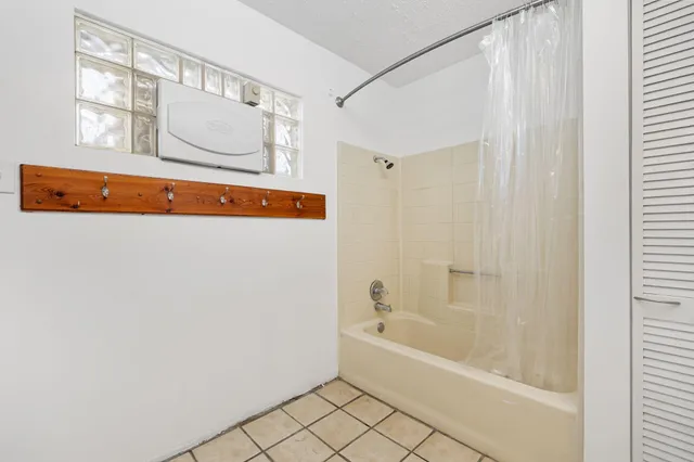 a bathroom with a bathtub and a shower