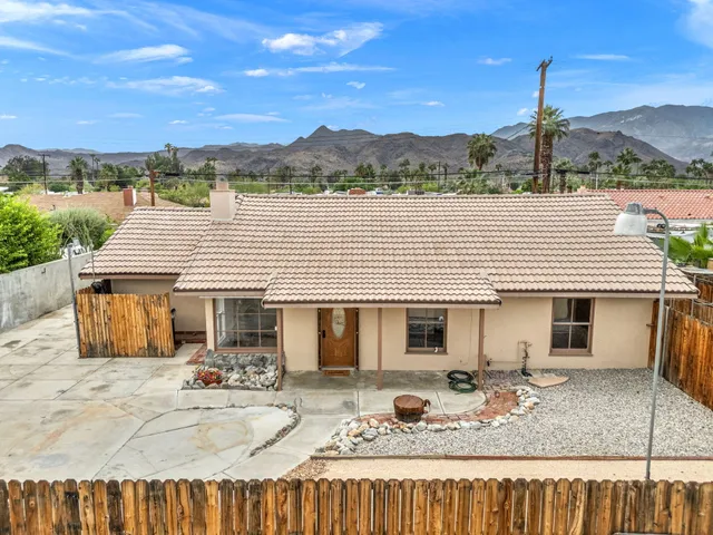 a front view of a house with trees