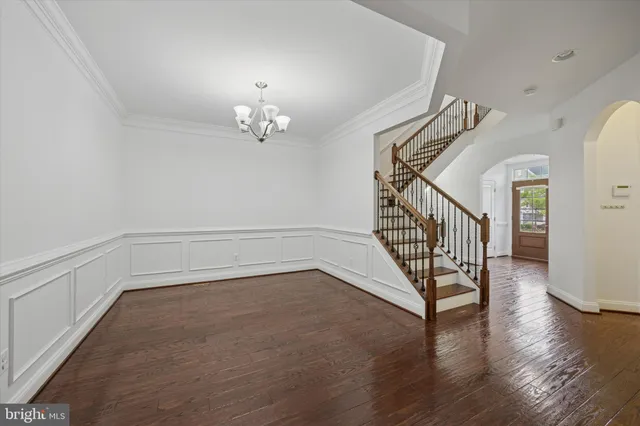 a view of a livingroom with wooden floor and stairs