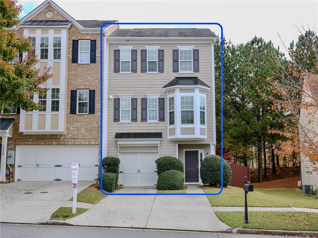 1218 Park Pass Way Suwanee, GA 30024 - Photo 1 of 23 a front view of a house with a garden