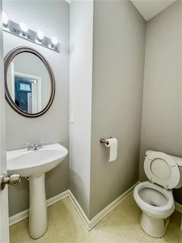 a white toilet sitting next to a bathroom sink