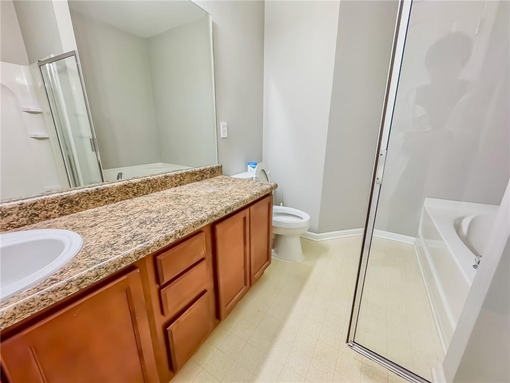 1218 Park Pass Way Suwanee, GA 30024 - Photo 16 of 23 a bathroom with a granite countertop sink and a mirror