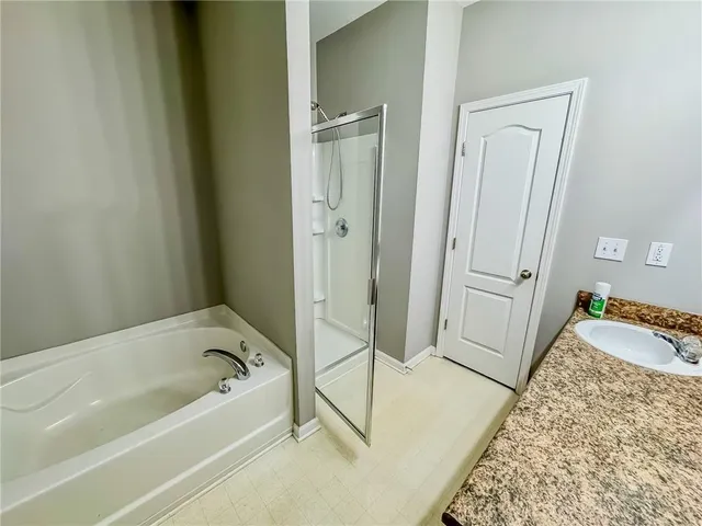 a bathroom with a bathtub and a shower
