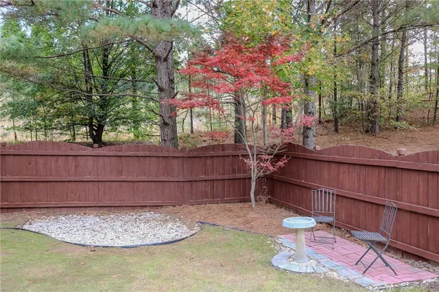 a wooden fence with trees in the background
