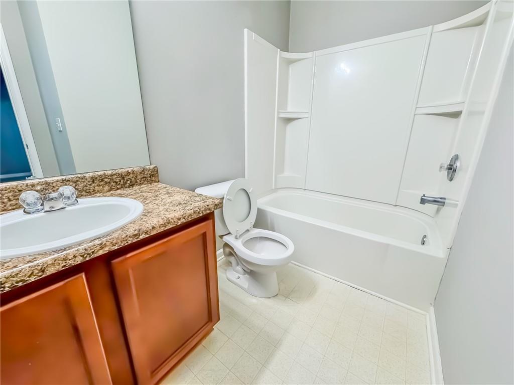 1218 Park Pass Way Suwanee, GA 30024 - Photo 4 of 23 a bathroom with a granite countertop sink toilet and shower