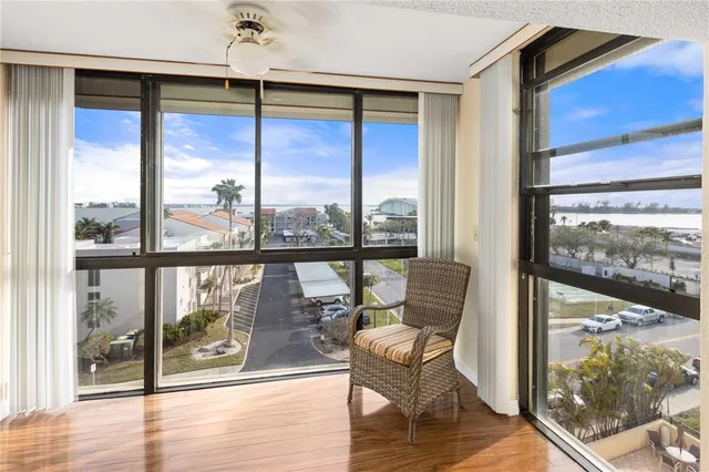 a view of a kitchen area with furniture and wooden floor
