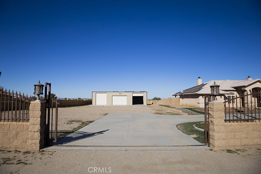 11830 Joshua Dell Road Victorville, CA 92392 - Photo 14 of 48 a front view of a house with parking space