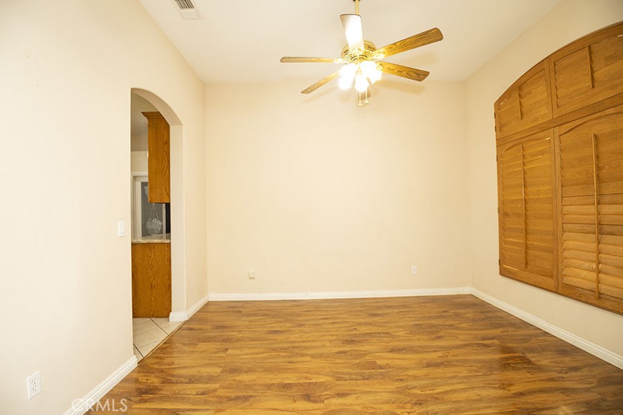 11830 Joshua Dell Road Victorville, CA 92392 - Photo 18 of 48 a view of an empty room with window and a ceiling fan