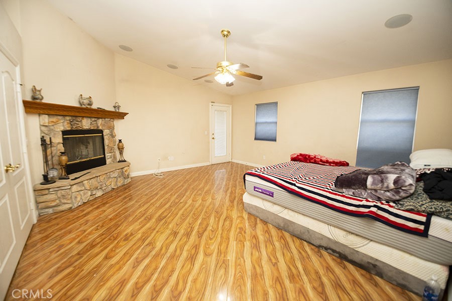 11830 Joshua Dell Road Victorville, CA 92392 - Photo 26 of 48 a bedroom with furniture and a chandelier