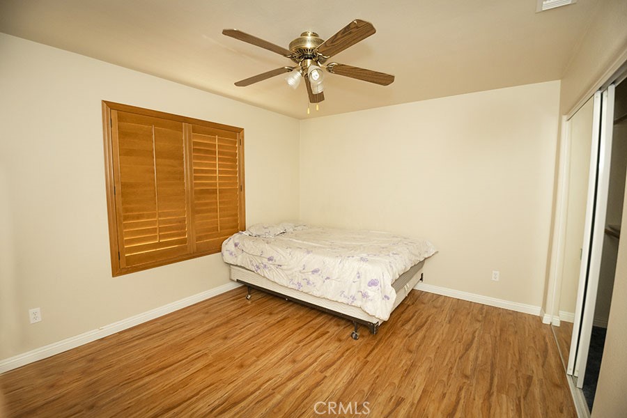 11830 Joshua Dell Road Victorville, CA 92392 - Photo 34 of 48 a view of a room with wooden floor and a ceiling fan