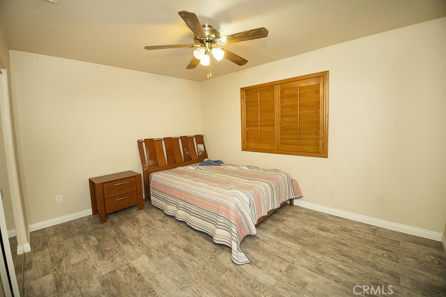 11830 Joshua Dell Road Victorville, CA 92392 - Photo 36 of 48 a bedroom with a bed and a couch