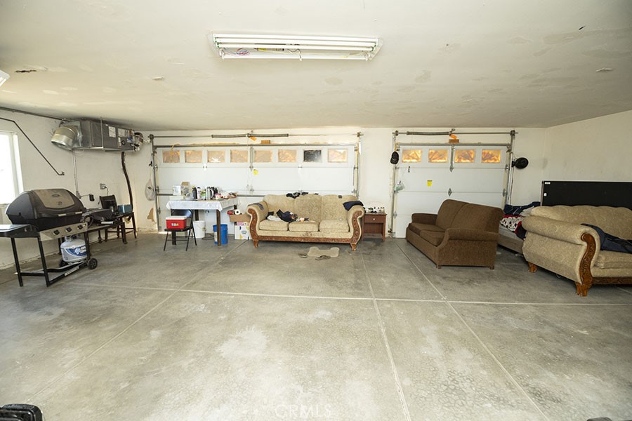 11830 Joshua Dell Road Victorville, CA 92392 - Photo 40 of 48 a living room with furniture and a table