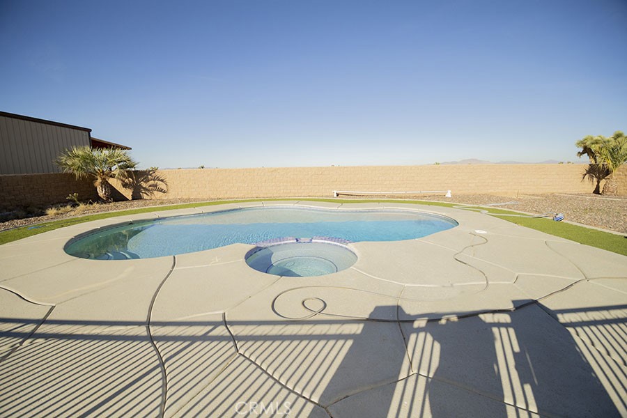 11830 Joshua Dell Road Victorville, CA 92392 - Photo 43 of 48 a view of a swimming pool with a lounge chair