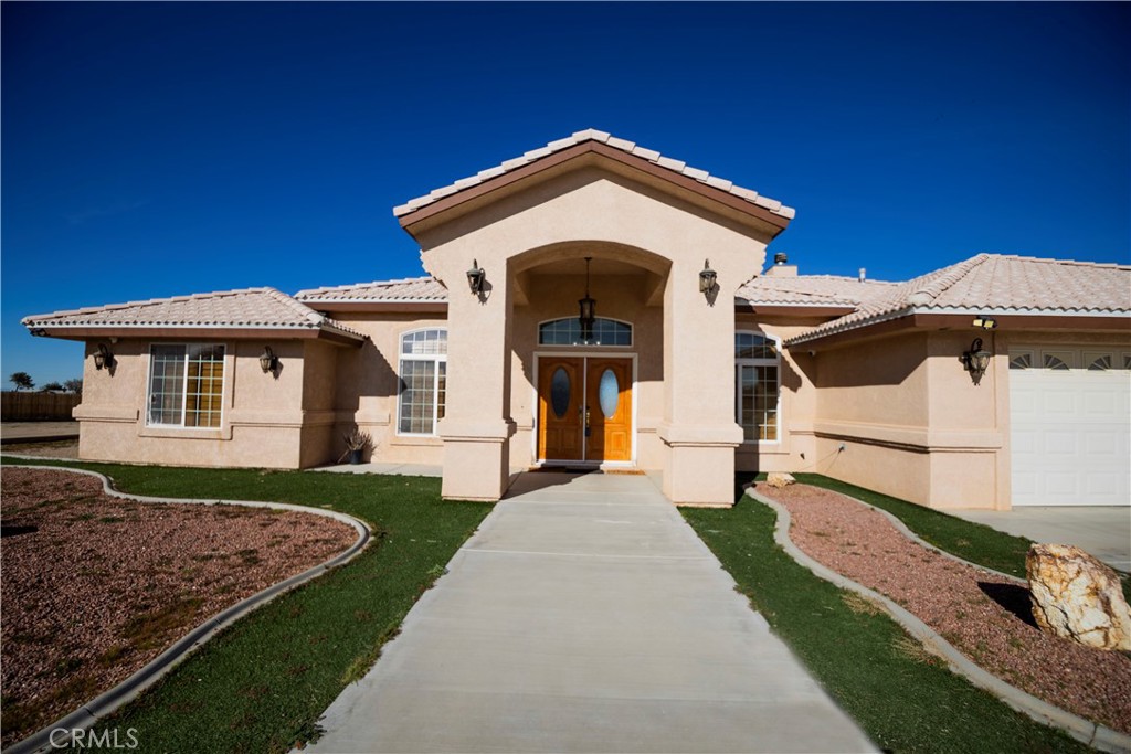 11830 Joshua Dell Road Victorville, CA 92392 - Photo 6 of 48 a front view of a house with a yard