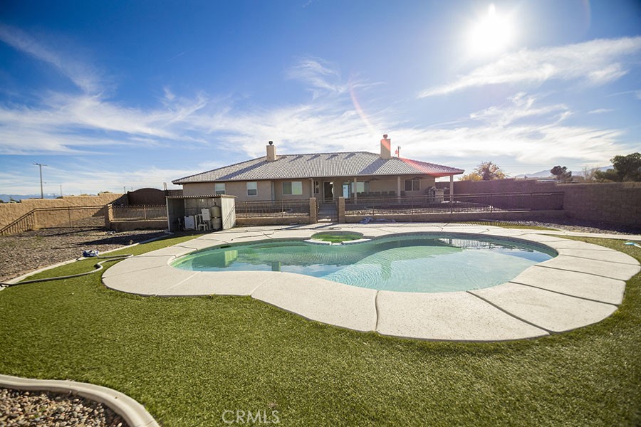 11830 Joshua Dell Road Victorville, CA 92392 - Photo 8 of 48 a view of a house with swimming pool and yard