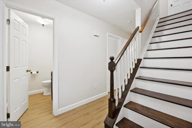 a view of entryway with wooden floor and stairs