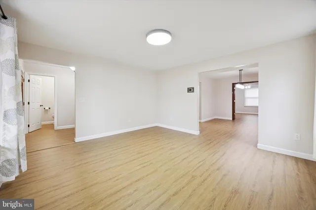 a view of an empty room and wooden floor