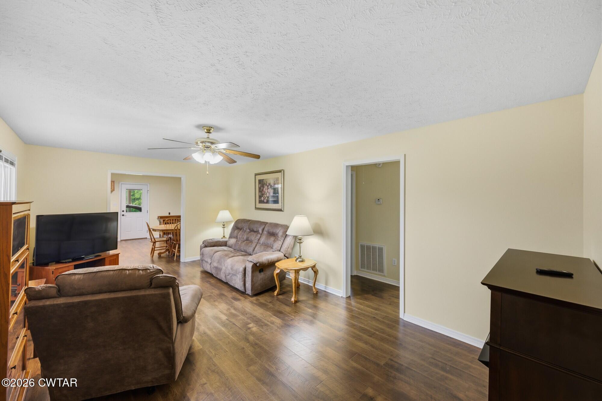 944 Brooksie Thompson Road Decaturville, TN 38329 - Photo 23 of 47 a living room with furniture and a flat screen tv