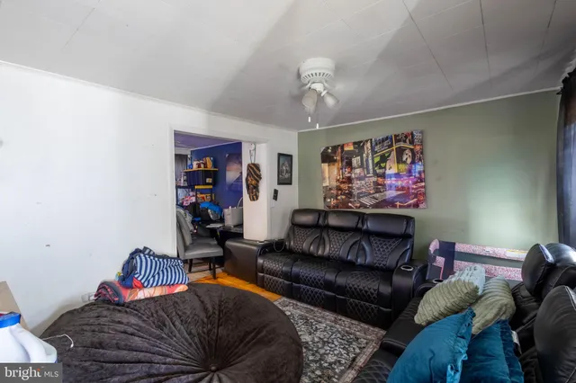 a living room with furniture a rug and a wall painting