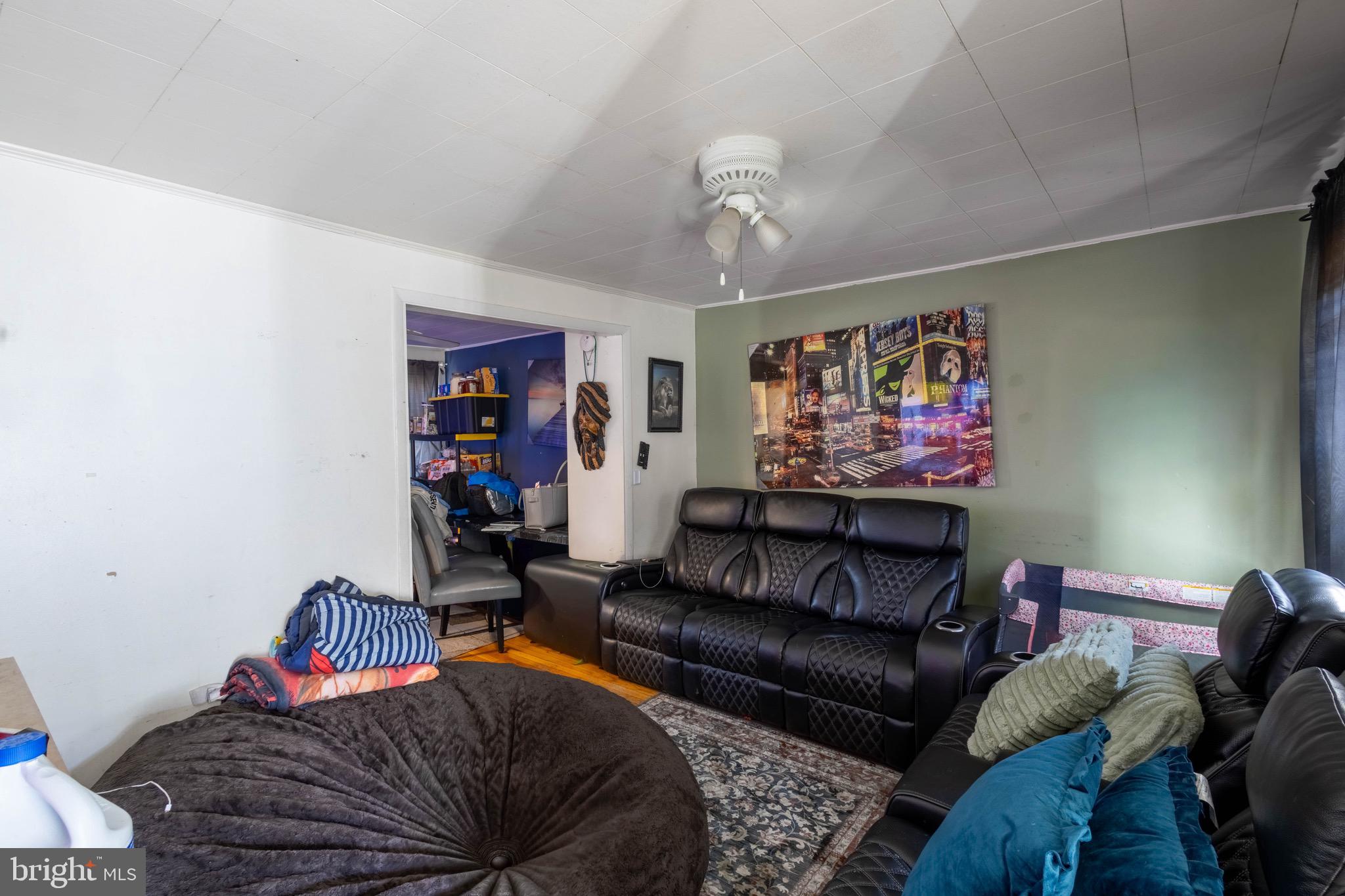 35 Kinship Road Baltimore, MD 21222 - Photo 3 of 15 a living room with furniture a rug and a wall painting