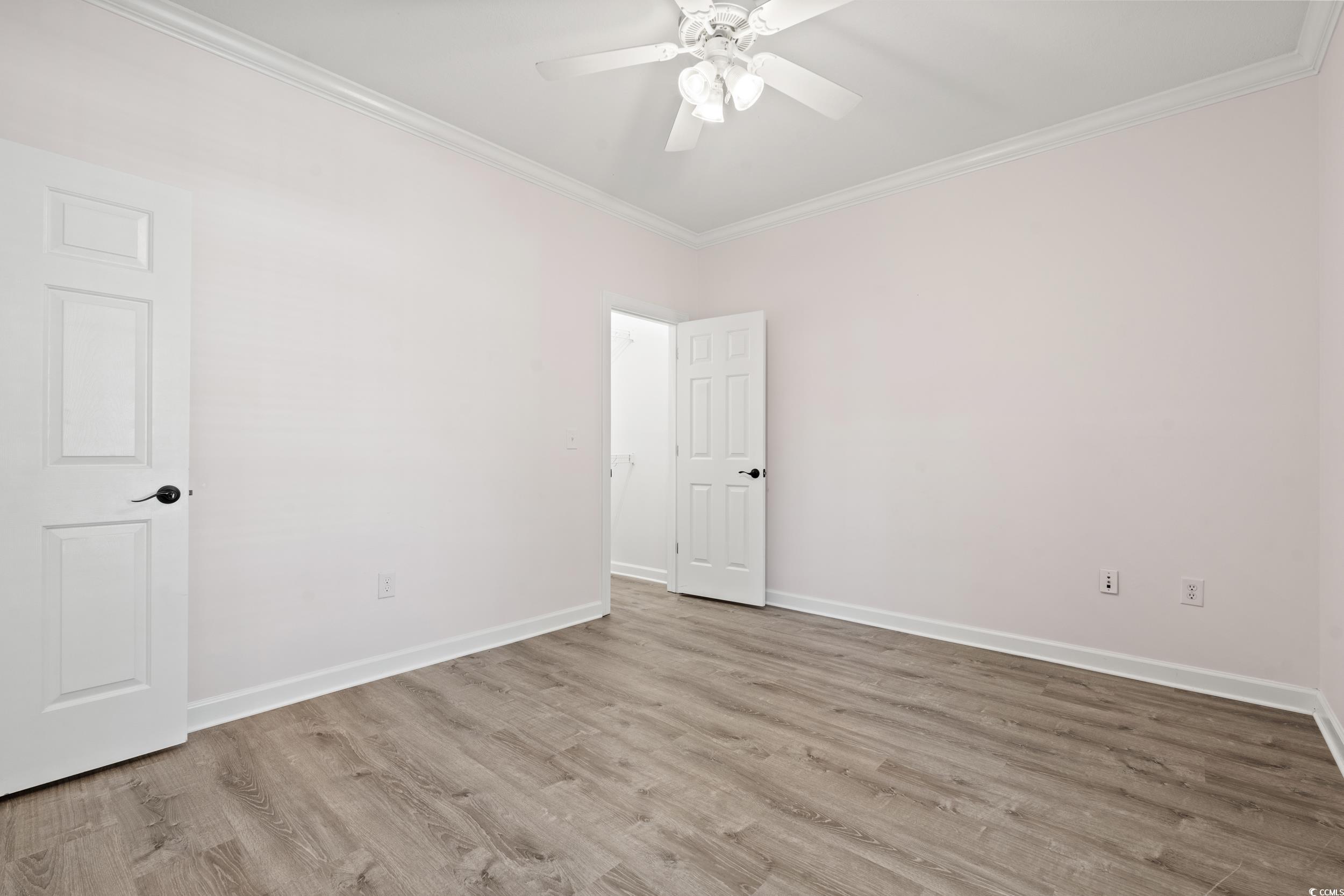 607 Sunnyside Drive, Unit 201 Murrells Inlet, SC 29576 - Photo 20 of 36 Empty room featuring ornamental molding, light woo