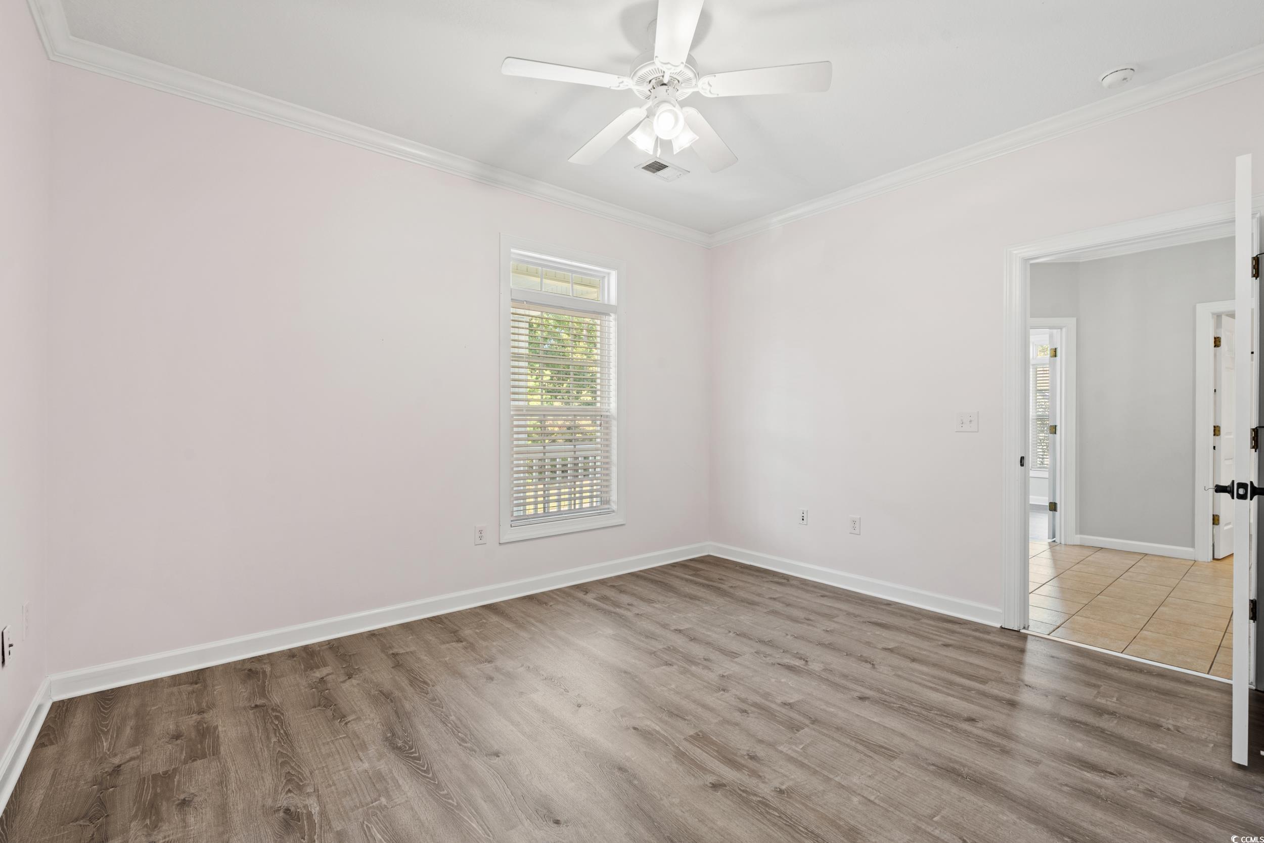 607 Sunnyside Drive, Unit 201 Murrells Inlet, SC 29576 - Photo 23 of 36 Unfurnished room with crown molding, hardwood / wo