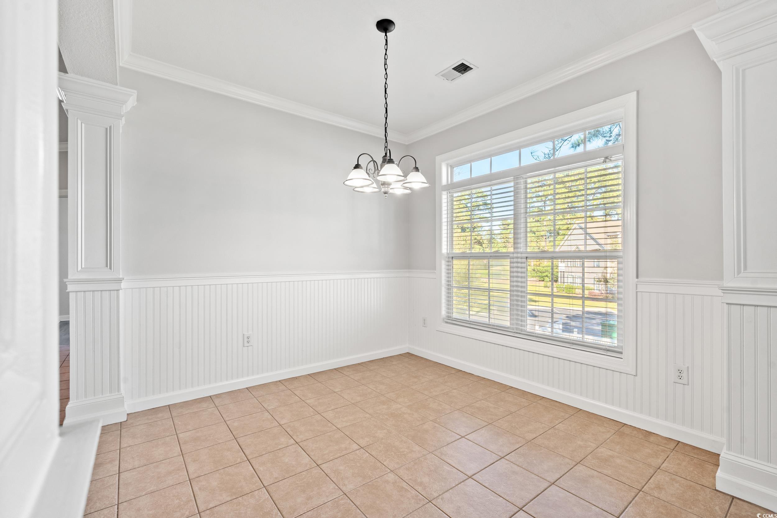 607 Sunnyside Drive, Unit 201 Murrells Inlet, SC 29576 - Photo 9 of 36 Empty room featuring crown molding, decorative col