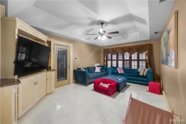 a bedroom with furniture a flat screen tv and a window