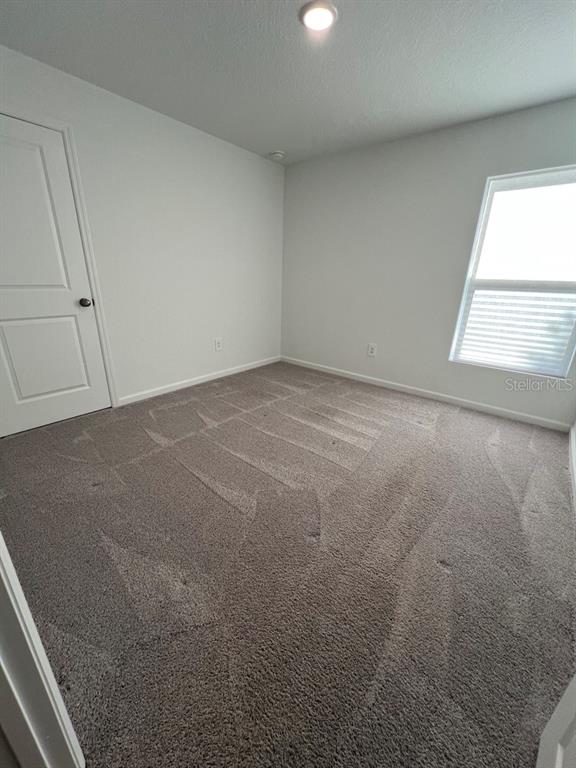 9131 Swiss Road Spring Hill, FL 34606 - Photo 16 of 16 a view of an empty room and a window