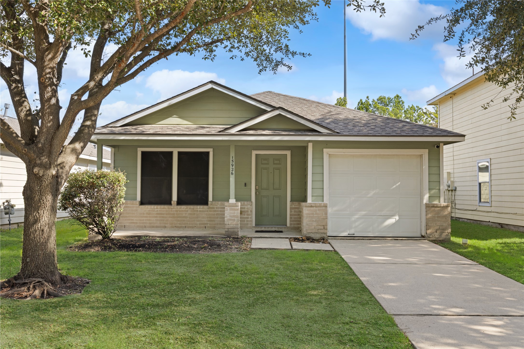 15926 Colonial Bridge Lane Houston, TX 77073 - Photo 1 of 27 a front view of a house with a yard and garage