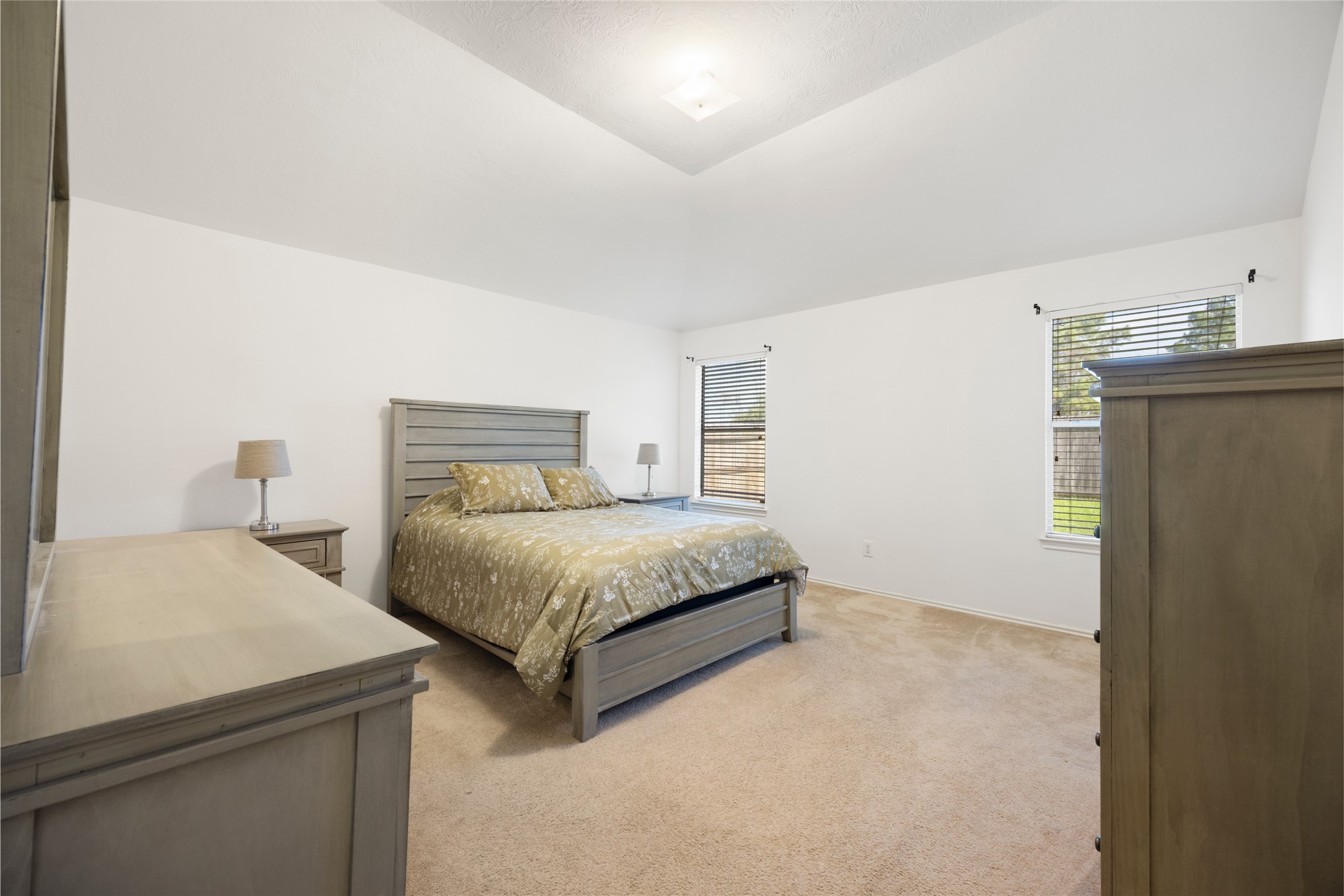 15926 Colonial Bridge Lane Houston, TX 77073 - Photo 14 of 27 a bedroom with a bed and a refrigerator