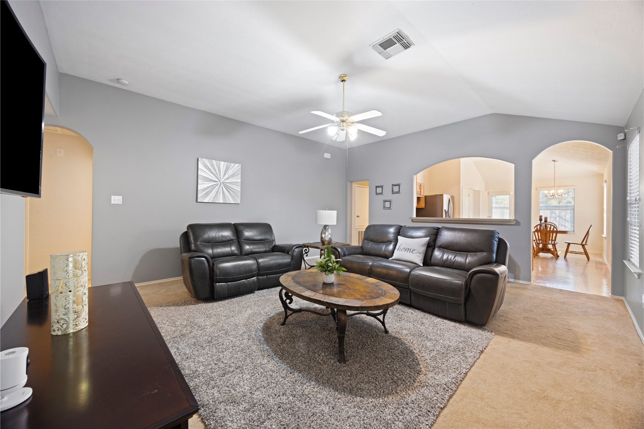 15926 Colonial Bridge Lane Houston, TX 77073 - Photo 5 of 27 a living room with furniture a rug and a chandelier