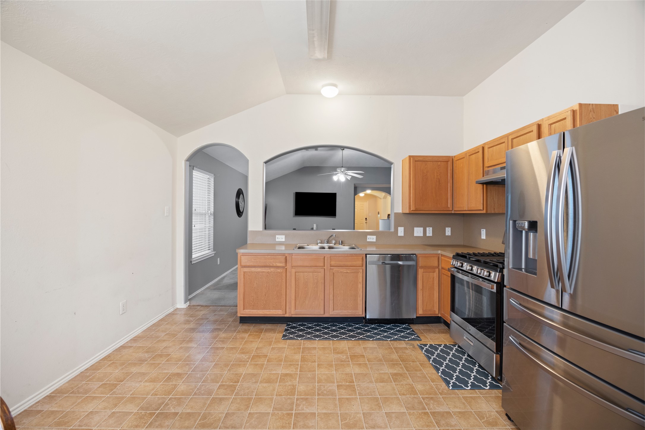 15926 Colonial Bridge Lane Houston, TX 77073 - Photo 10 of 27 a kitchen with a refrigerator sink and stove top oven