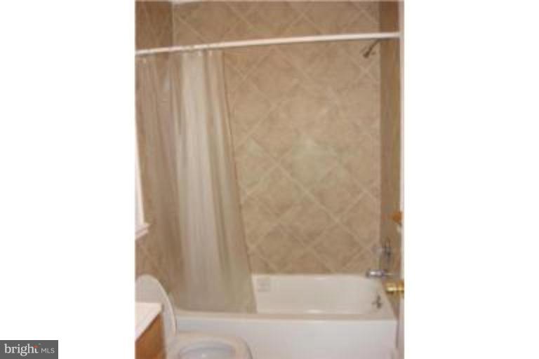 3511 Patuxent Road Huntingtown, MD 20639 - Photo 12 of 23 a bathroom with a bathtub and a shower