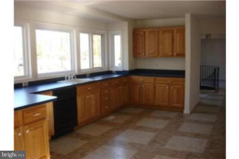 3511 Patuxent Road Huntingtown, MD 20639 - Photo 3 of 23 a kitchen with granite countertop a refrigerator and a sink