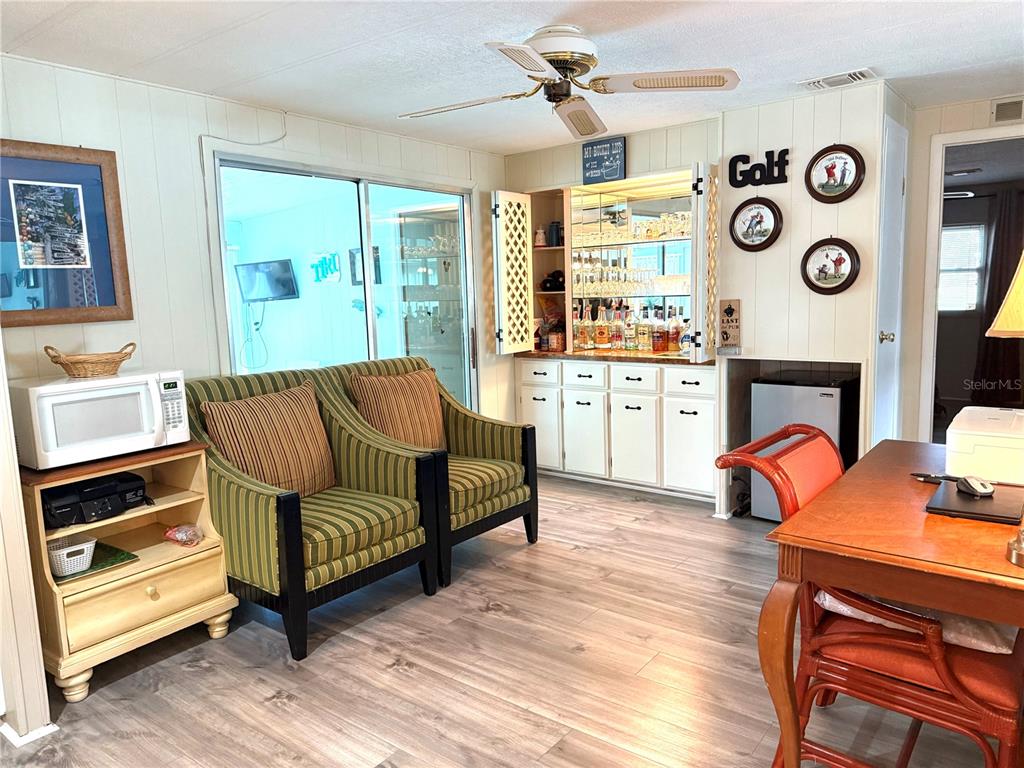 8010 Highpoint Boulevard Brooksville, FL 34613 - Photo 11 of 32 a living room with furniture and a fireplace