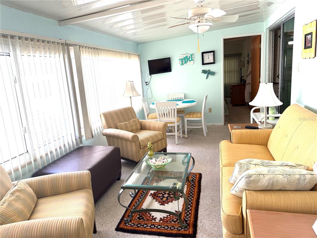 8010 Highpoint Boulevard Brooksville, FL 34613 - Photo 12 of 32 a living room with furniture and a large window